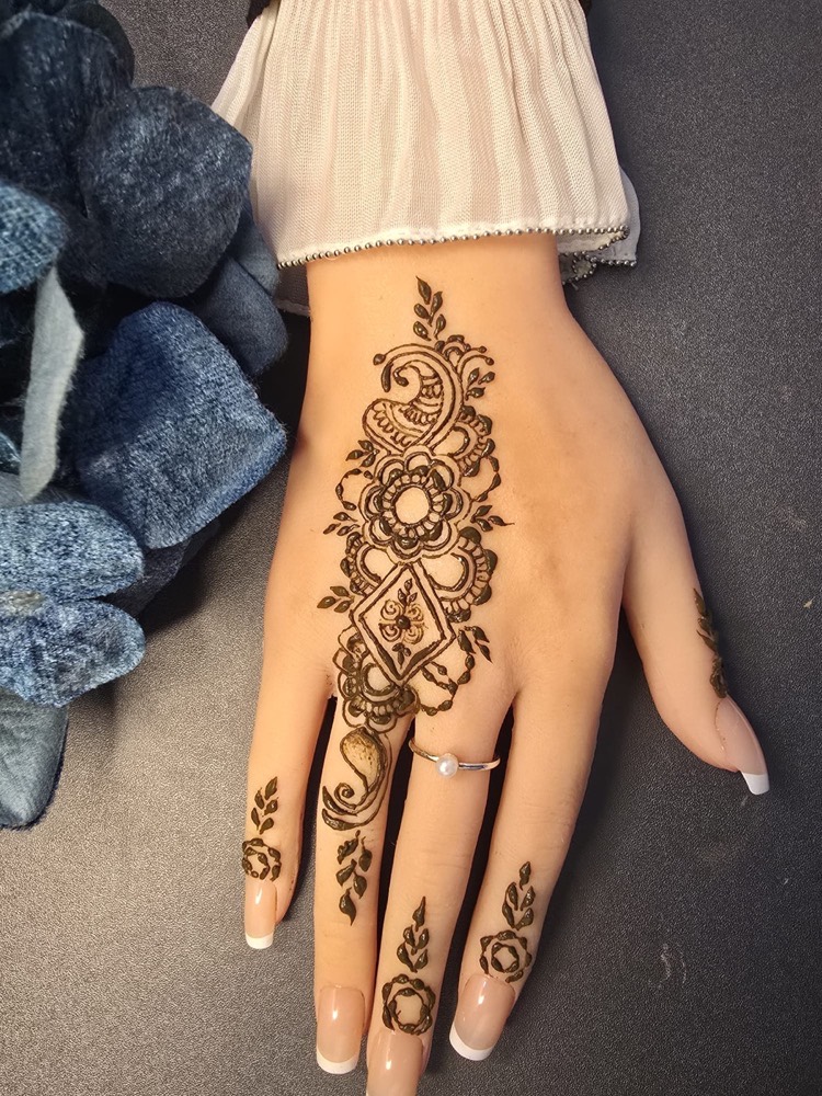 Arabic mehndi design with flowing florals and detailed hand coverage