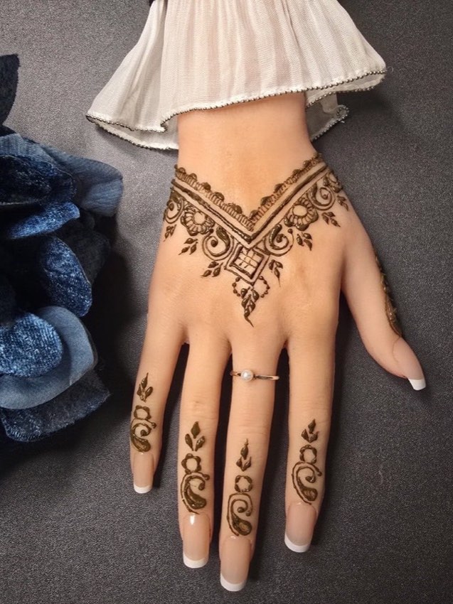 Fresh Mehndi Aura henna design with wrist and finger detail