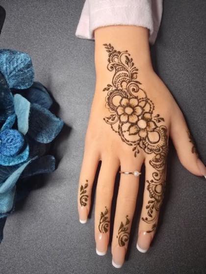 Floral Arabic mehndi design with flowing hand coverage